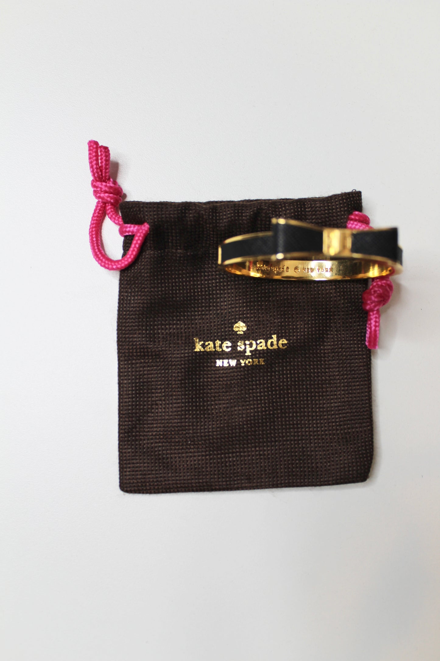 Kate Spade take a bow black/gold bangle with hinge