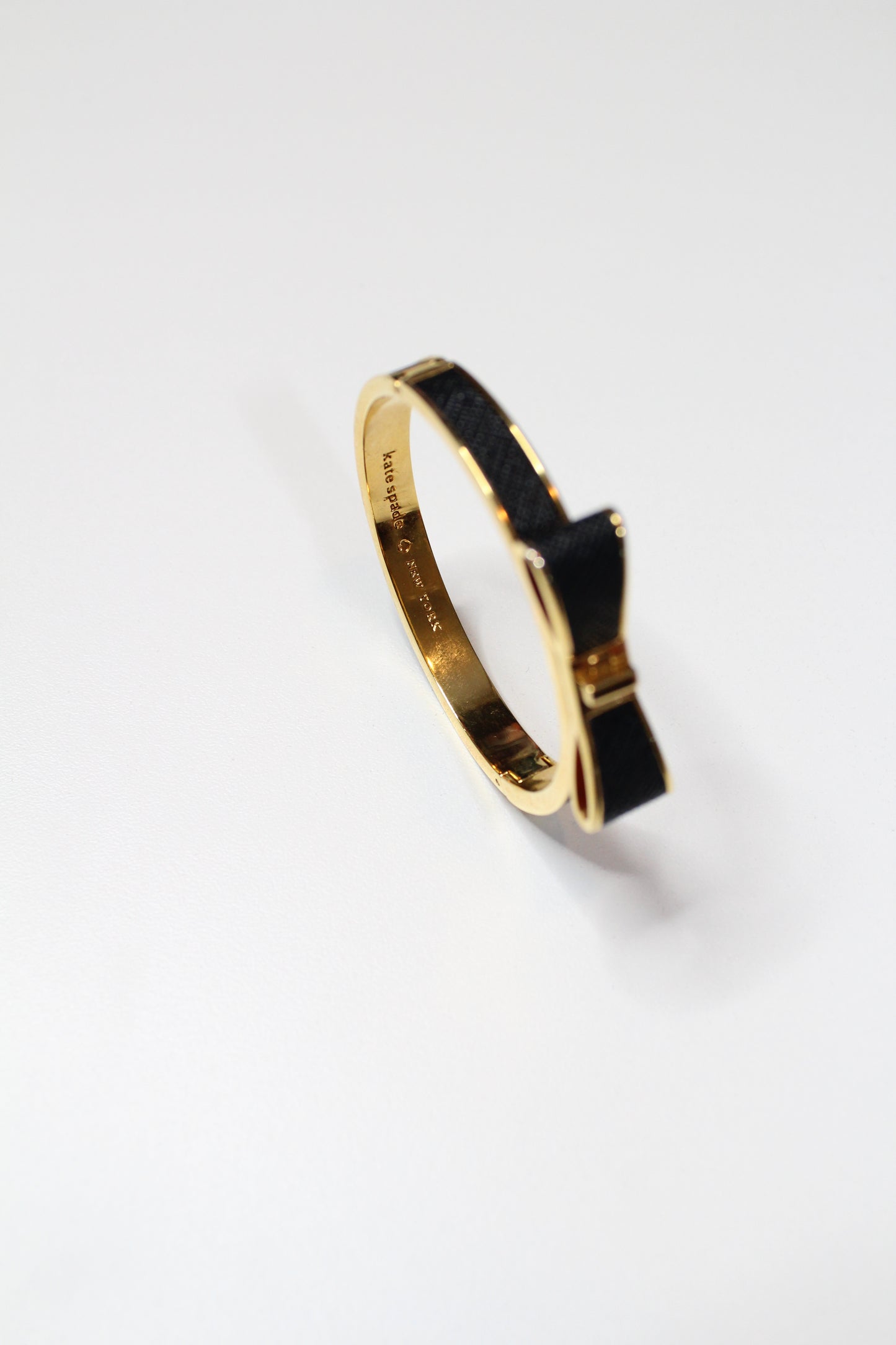 Kate Spade take a bow black/gold bangle with hinge